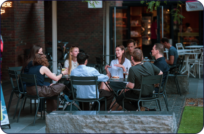 digitalRG team talking around outdoor cafe tables