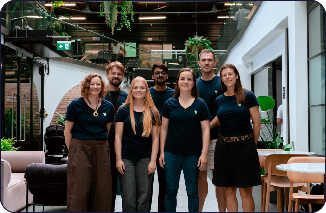 digitalRG team standing together in the office atrium, wearing navy t-shirts