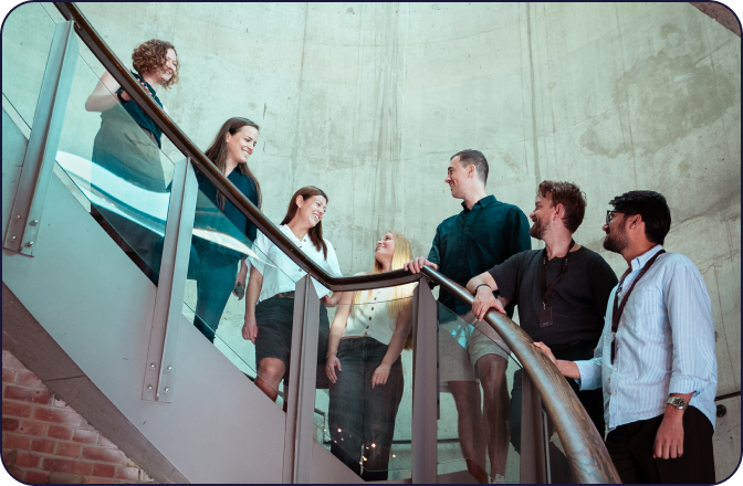 digitalRG team gathered on a spiral staircase